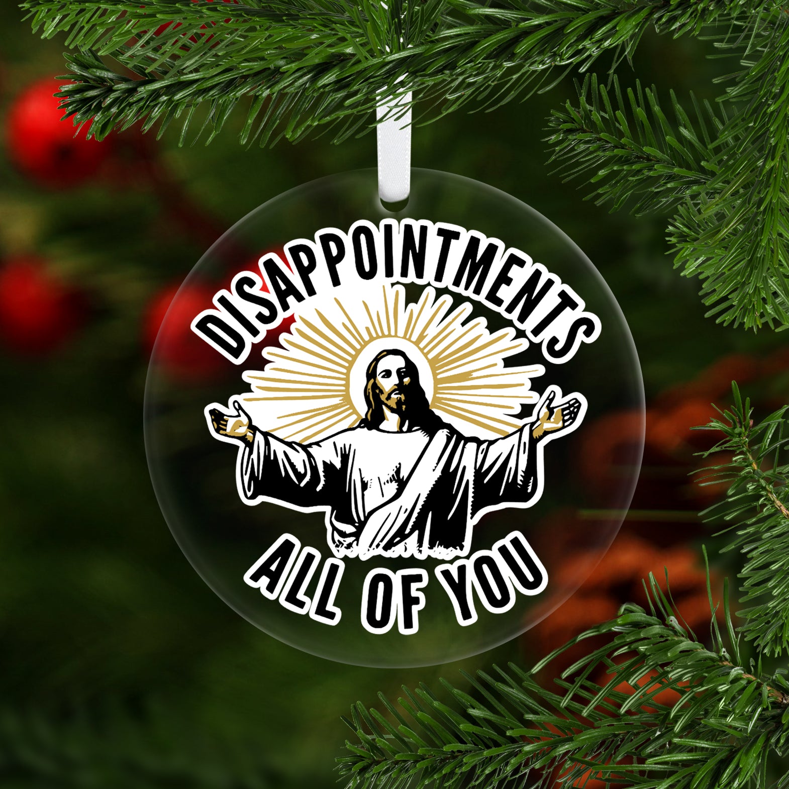 Decorative Christmas ornament with a religious design and text on a tree.